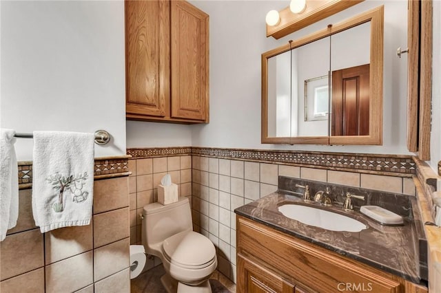 1317 Pacific St, Redlands, CA 92373 - bathroom with toilet, vanity, a wainscoted wall, and tile walls
