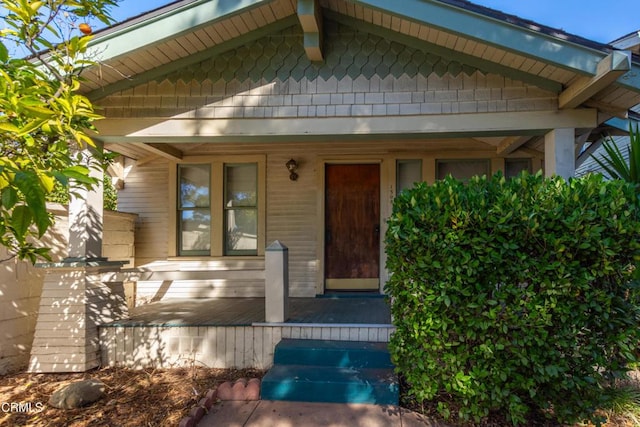 property entrance with covered porch