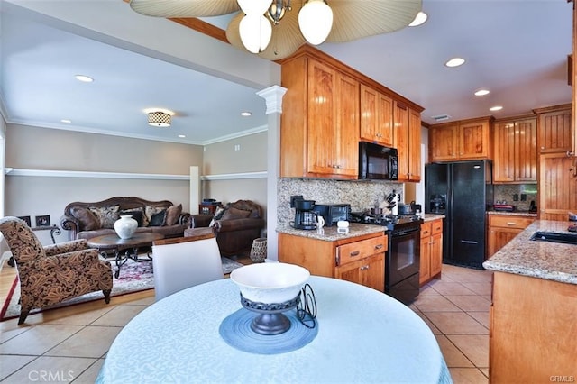 kitchen featuring crown molding, black appliances, light tile patterned floors, and decorative backsplash