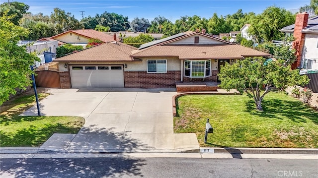 view of front of property featuring a garage and a front lawn