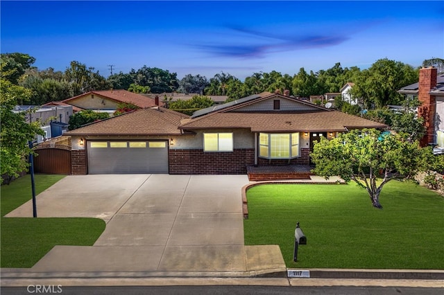 view of front of property featuring a front yard and a garage