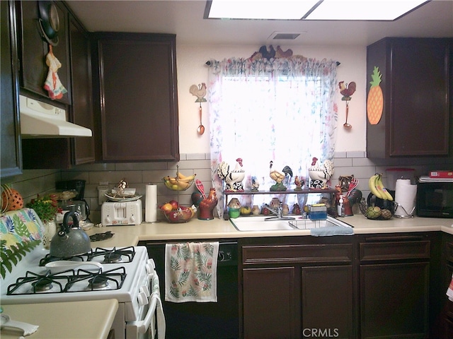 kitchen with white range with gas stovetop, exhaust hood, dark brown cabinets, and tasteful backsplash