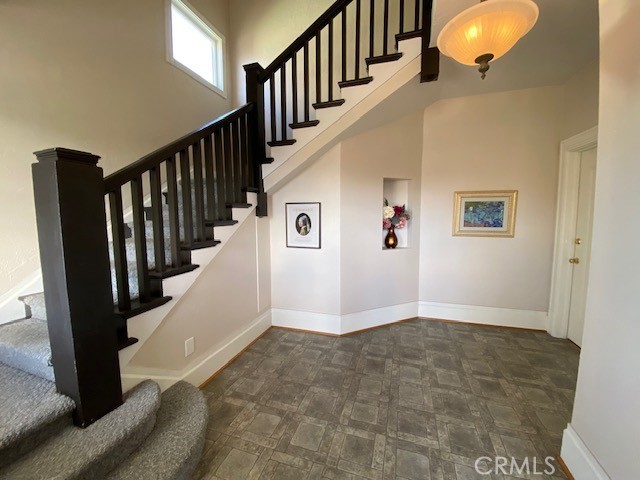 staircase featuring a towering ceiling