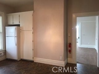 kitchen with white cabinets and white refrigerator