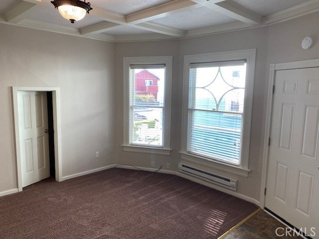 interior space with coffered ceiling, beam ceiling, and a healthy amount of sunlight