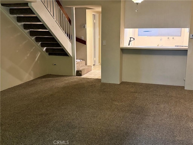 unfurnished living room with light colored carpet