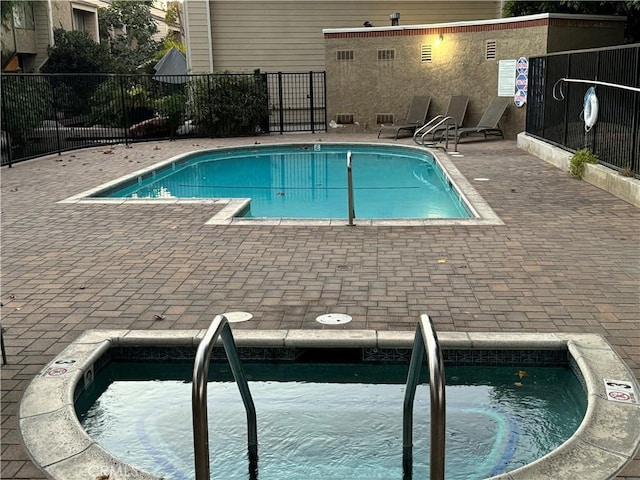 view of swimming pool featuring a community hot tub