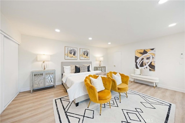 bedroom featuring light hardwood / wood-style flooring and a closet