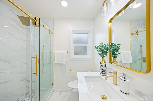 bathroom featuring vanity, a shower with shower door, and toilet