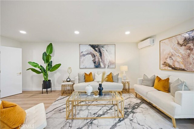 living room with hardwood / wood-style floors and an AC wall unit