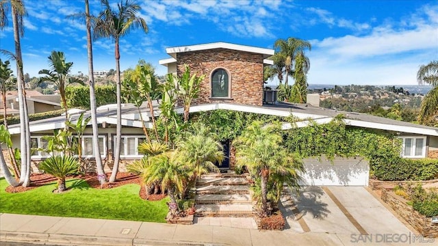 view of front facade with a front lawn and a garage