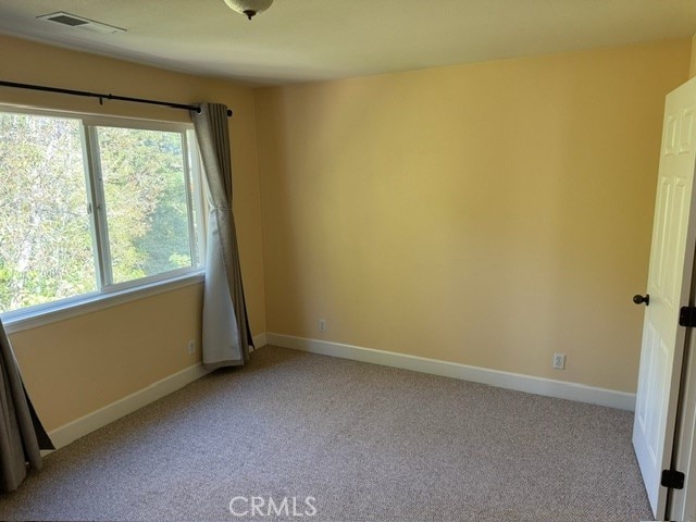 unfurnished room with light colored carpet