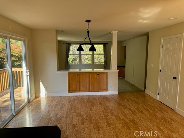 kitchen featuring decorative light fixtures, light hardwood / wood-style flooring, and a healthy amount of sunlight