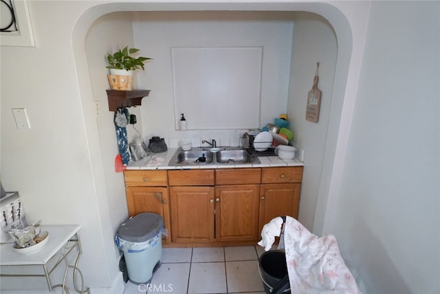 interior space featuring sink and light tile patterned floors