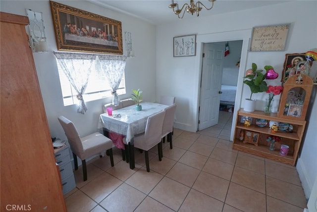 dining room featuring a notable chandelier and light tile patterned floors