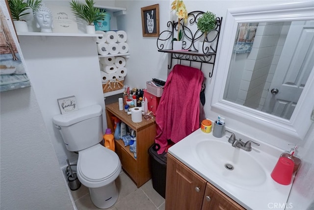 bathroom with vanity, toilet, and tile patterned floors