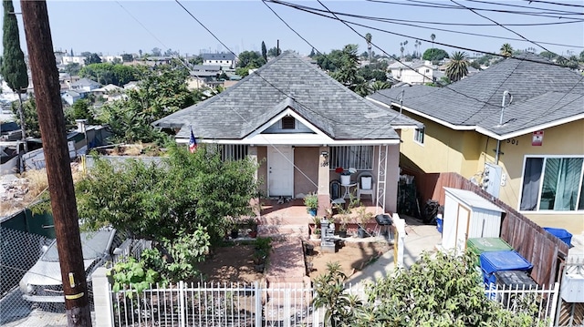 bungalow-style home with a patio area and a storage shed