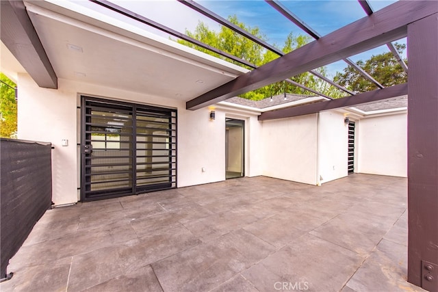 view of patio featuring glass enclosure