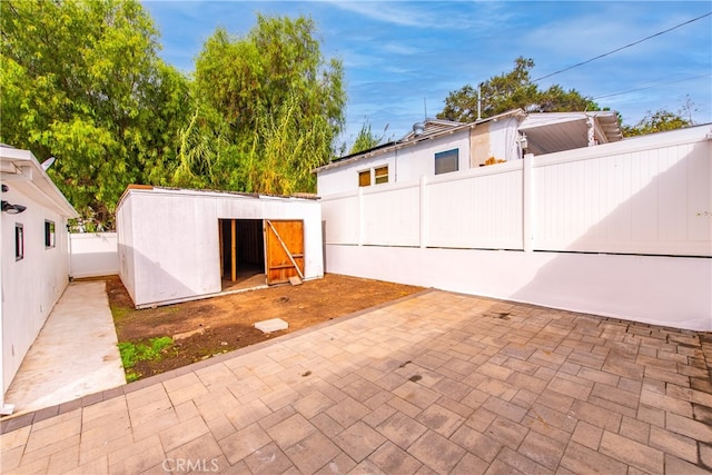 view of patio with a storage shed