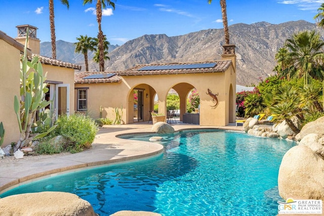 view of pool featuring a patio area and a mountain view