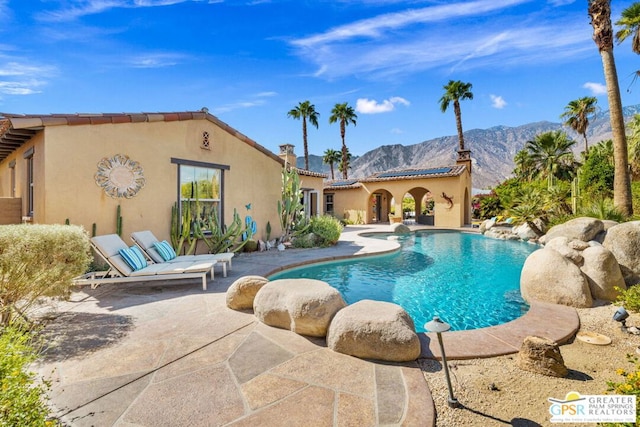 view of pool featuring a patio and a mountain view