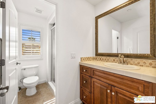 bathroom with decorative backsplash, walk in shower, toilet, vanity, and tile patterned flooring