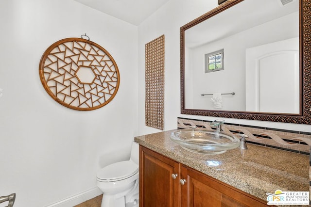 bathroom with vanity and toilet