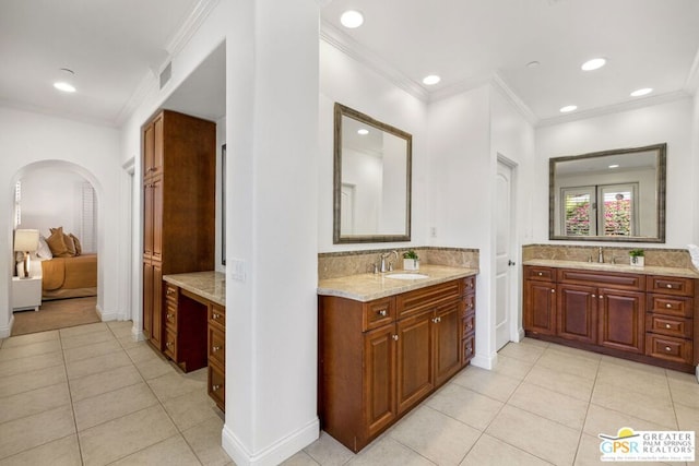 bathroom featuring vanity, crown molding, backsplash, and tile patterned floors