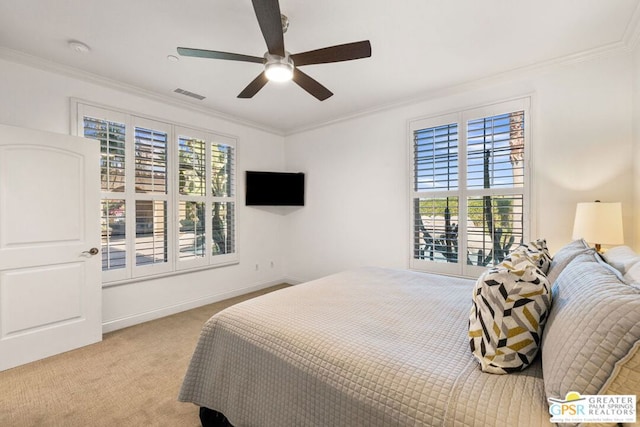 bedroom with crown molding, light colored carpet, and ceiling fan