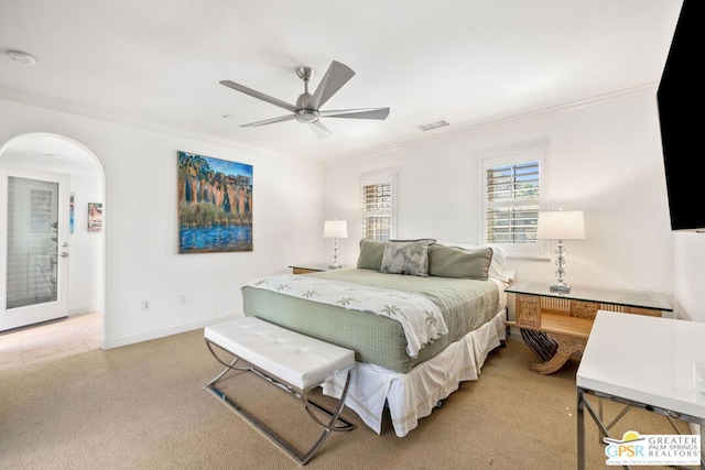 bedroom with ceiling fan, light carpet, and ornamental molding