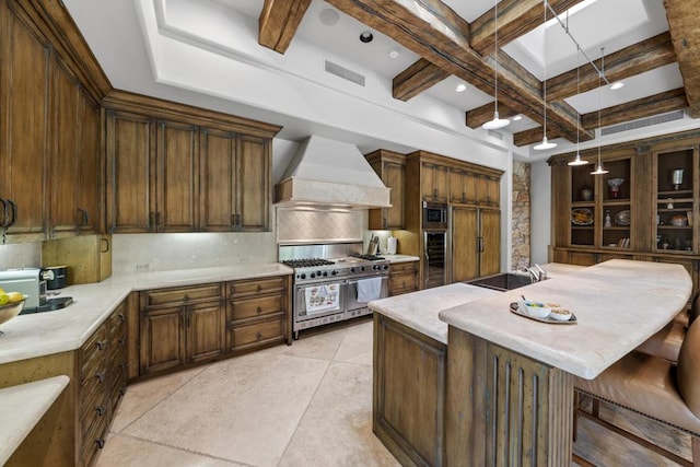 kitchen featuring coffered ceiling, stainless steel appliances, pendant lighting, beam ceiling, and premium range hood