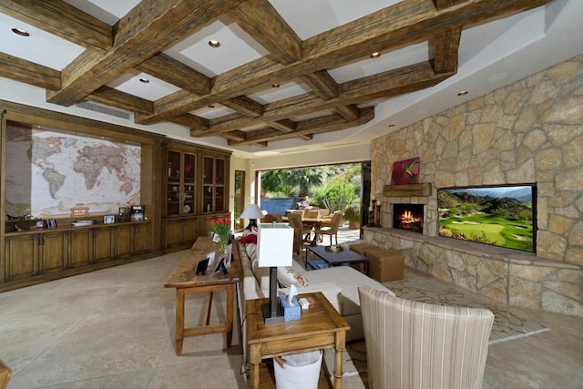 living room featuring beam ceiling, coffered ceiling, and a fireplace