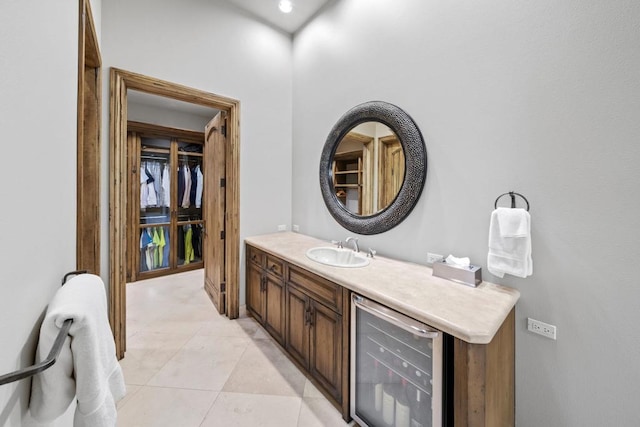 bathroom featuring vanity, tile patterned floors, and beverage cooler