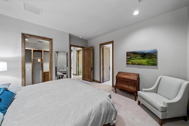 carpeted bedroom featuring a closet and a walk in closet