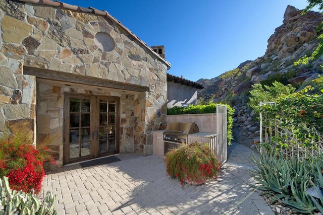 view of patio with french doors, a grill, and area for grilling