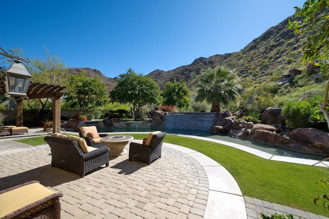 view of patio / terrace with a mountain view and a pergola