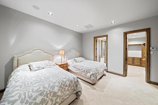 carpeted bedroom with a spacious closet