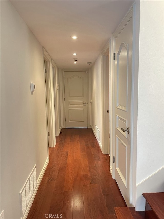 corridor featuring dark hardwood / wood-style flooring