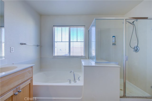 bathroom featuring vanity and shower with separate bathtub