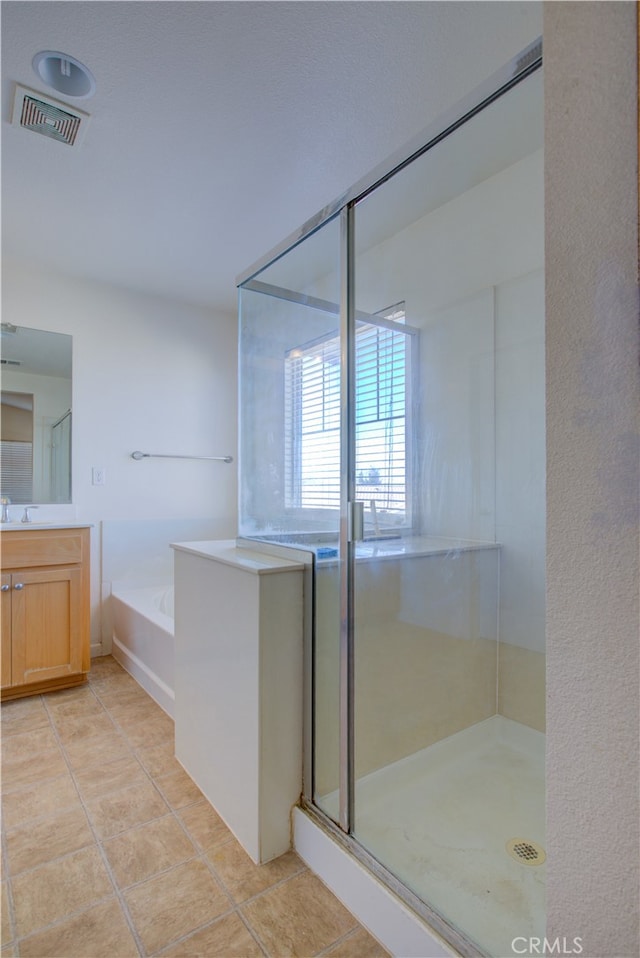 bathroom with vanity, separate shower and tub, and tile patterned flooring