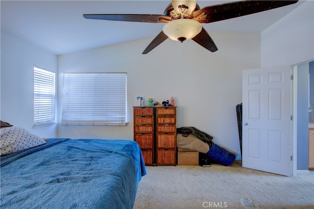 carpeted bedroom with vaulted ceiling and ceiling fan