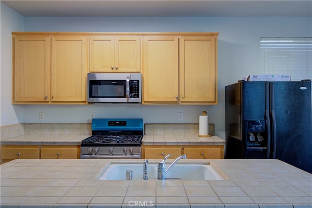 kitchen featuring tile countertops and stainless steel appliances