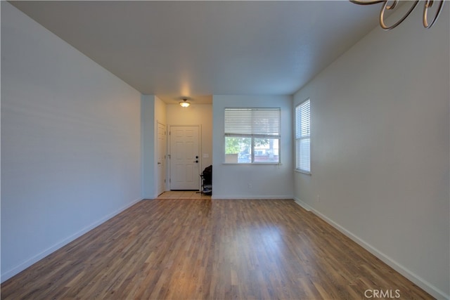 unfurnished living room with hardwood / wood-style flooring