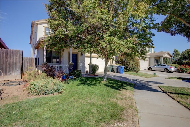 view of property hidden behind natural elements with a front lawn and a garage