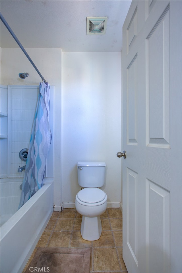 bathroom featuring toilet and shower / bath combo