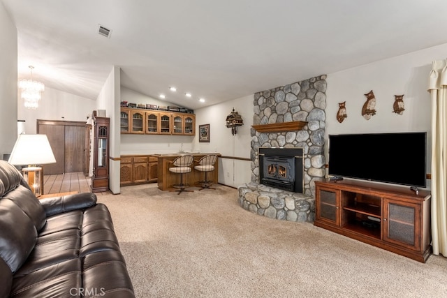 living room featuring lofted ceiling, bar area, light colored carpet, and a notable chandelier