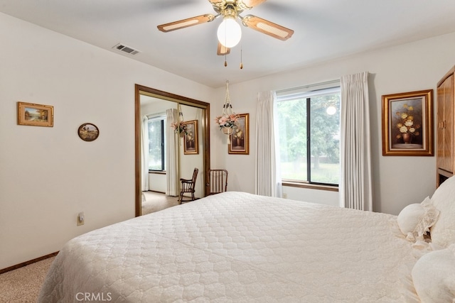 bedroom featuring a closet, light carpet, and ceiling fan