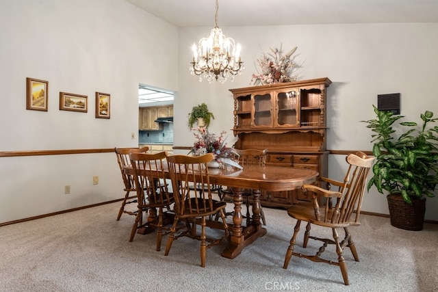 carpeted dining room with a chandelier