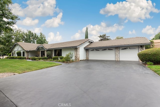 single story home featuring a front lawn and a garage