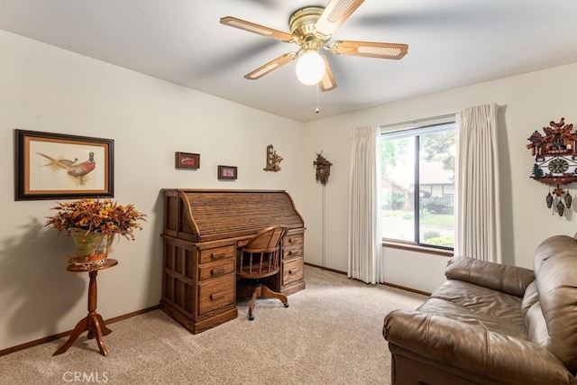 carpeted office space with ceiling fan